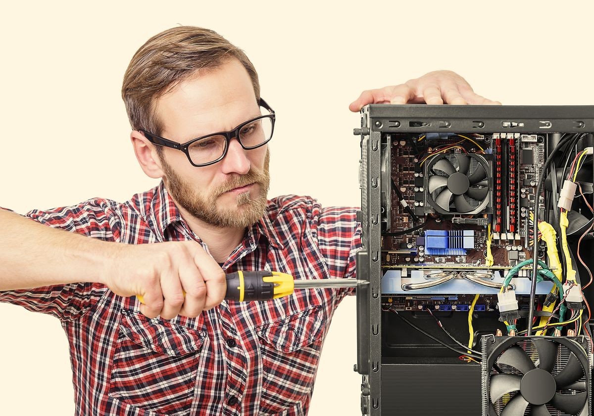 Technician repair assembles computer. Toned image.